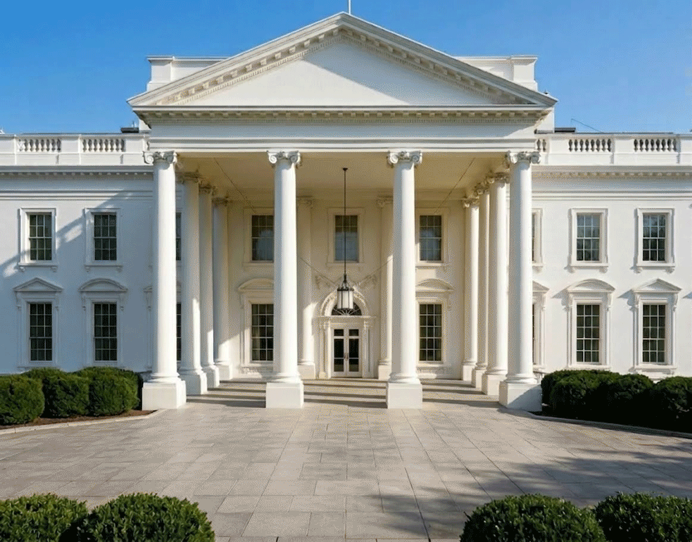 A surreal digital artwork of the White House, where the entire building has been transformed into a vibrant, monochromatic canary yellow. Overlaid across the facade and the foreground pavement is a large, black "smiley face" with a melting, graffiti-style paint-drip effect. The white neoclassical columns stand in sharp contrast against the yellow walls and the blue sky.